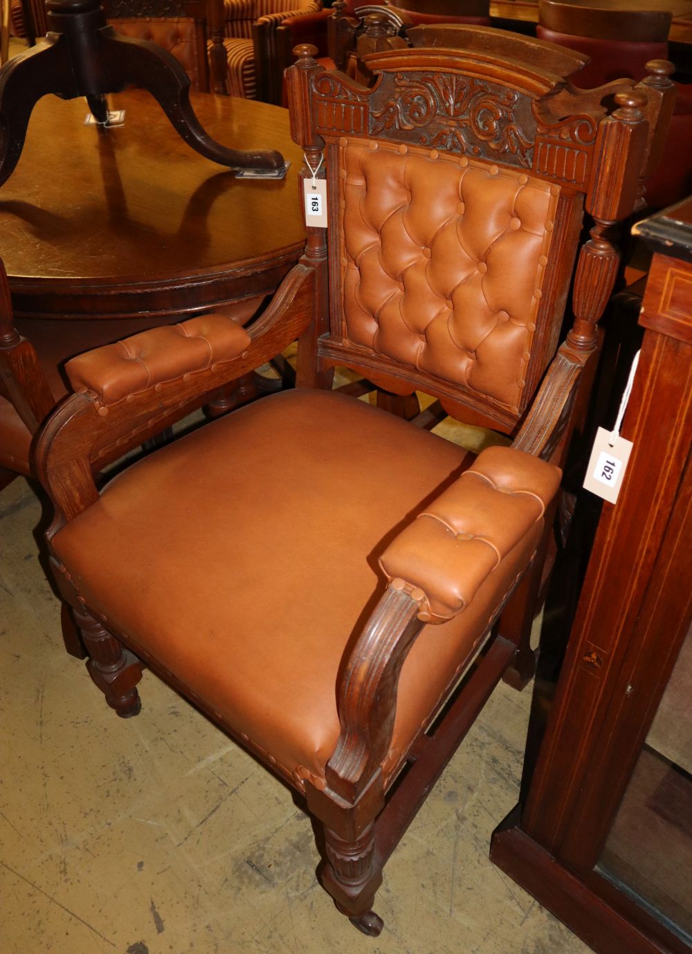 A set of eight Edwardian carved oak and tan leather upholstered dining chairs (two with arms)